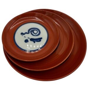 This is a Japanese Arita ware plate with a persimmon red glaze.